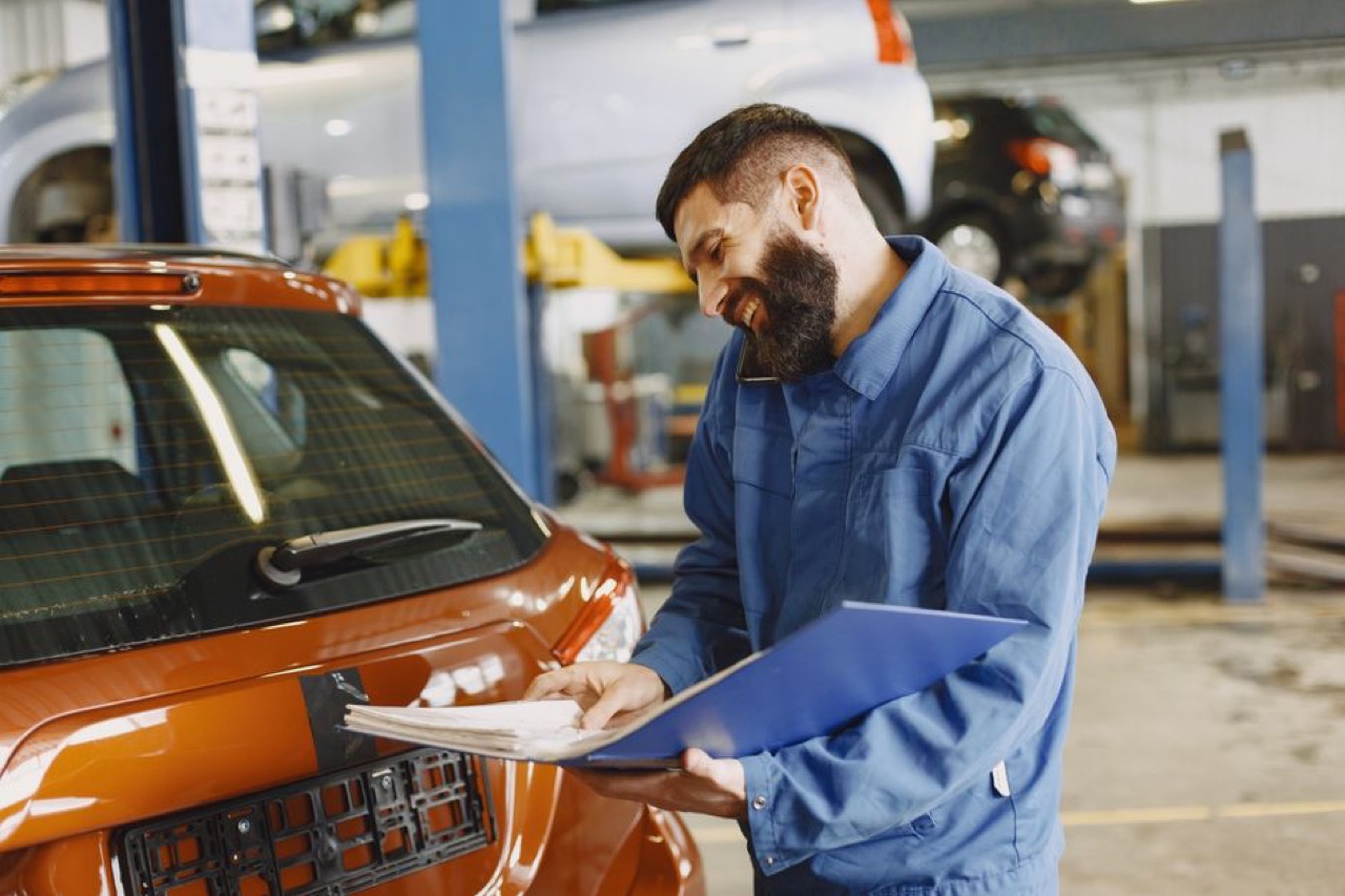Assessor inspecting car